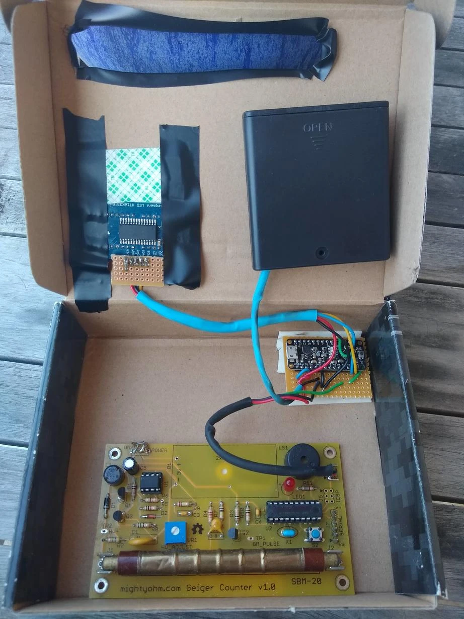 The dosimeter, open, showing the back of the display, the battery pack, the actual
sensor, and the microcontroller